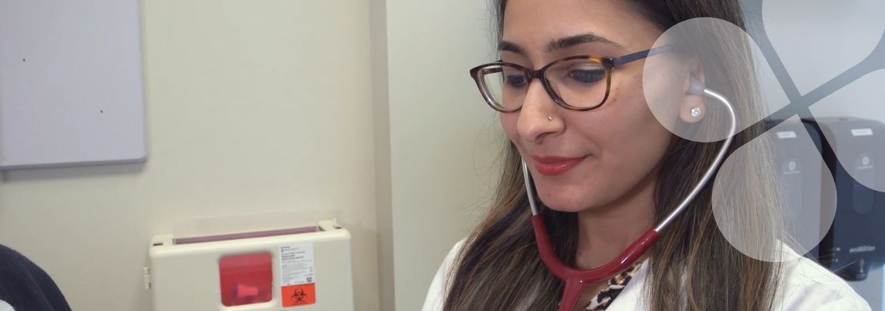 Closeup of a physician using a stethoscope in a clinic setting