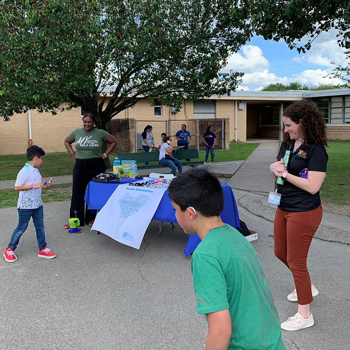 Children involved in an outdoor activity during a community event at a Harris Center-affiliated site.