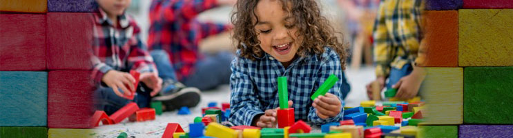 Happy children playing with blocks