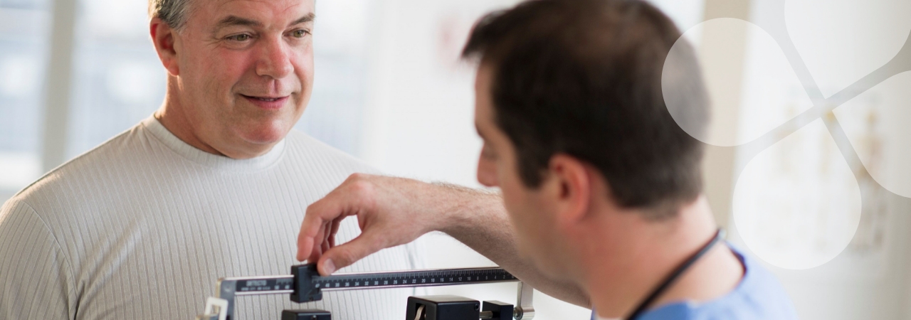 Harris Center healthcare provider nudging a scale weight as a patient looks on