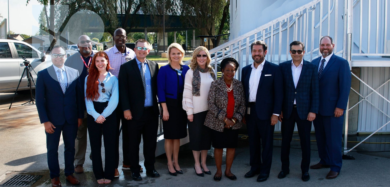 The Harris Center CEO, Wayne Young, and others gathered outside in front of a mobile care unit