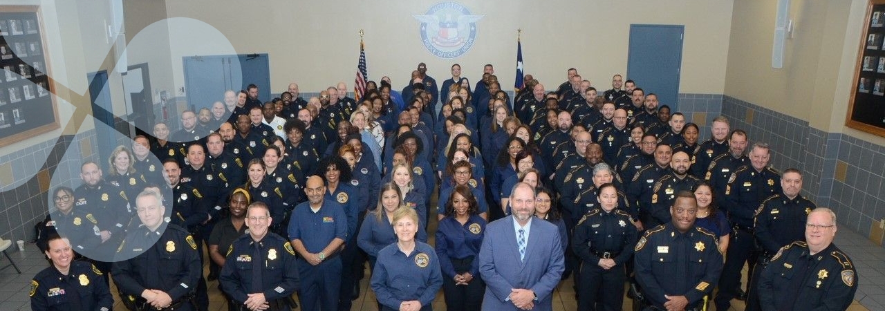 The Harris Center Crisis Services staff members lined up for an indoor group picture with CEO, Wayne Young 