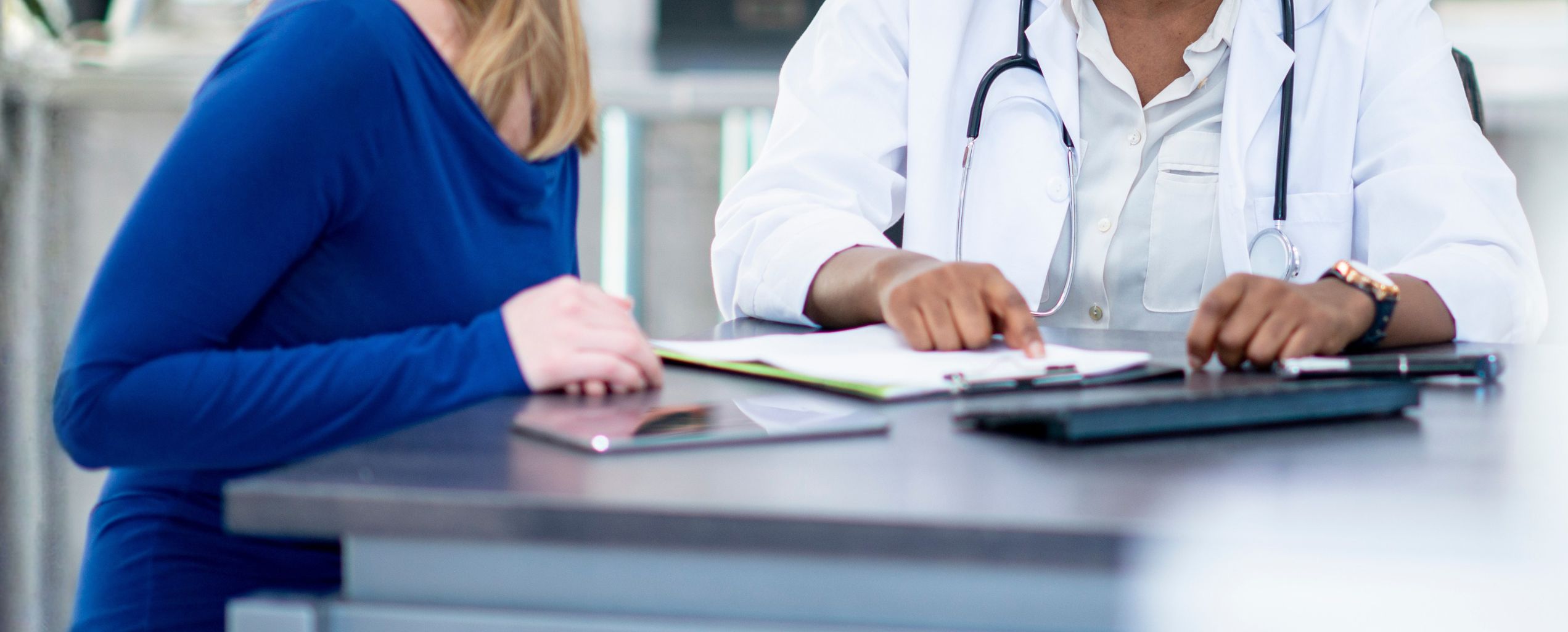 A doctor and patient reviewing health information together.
