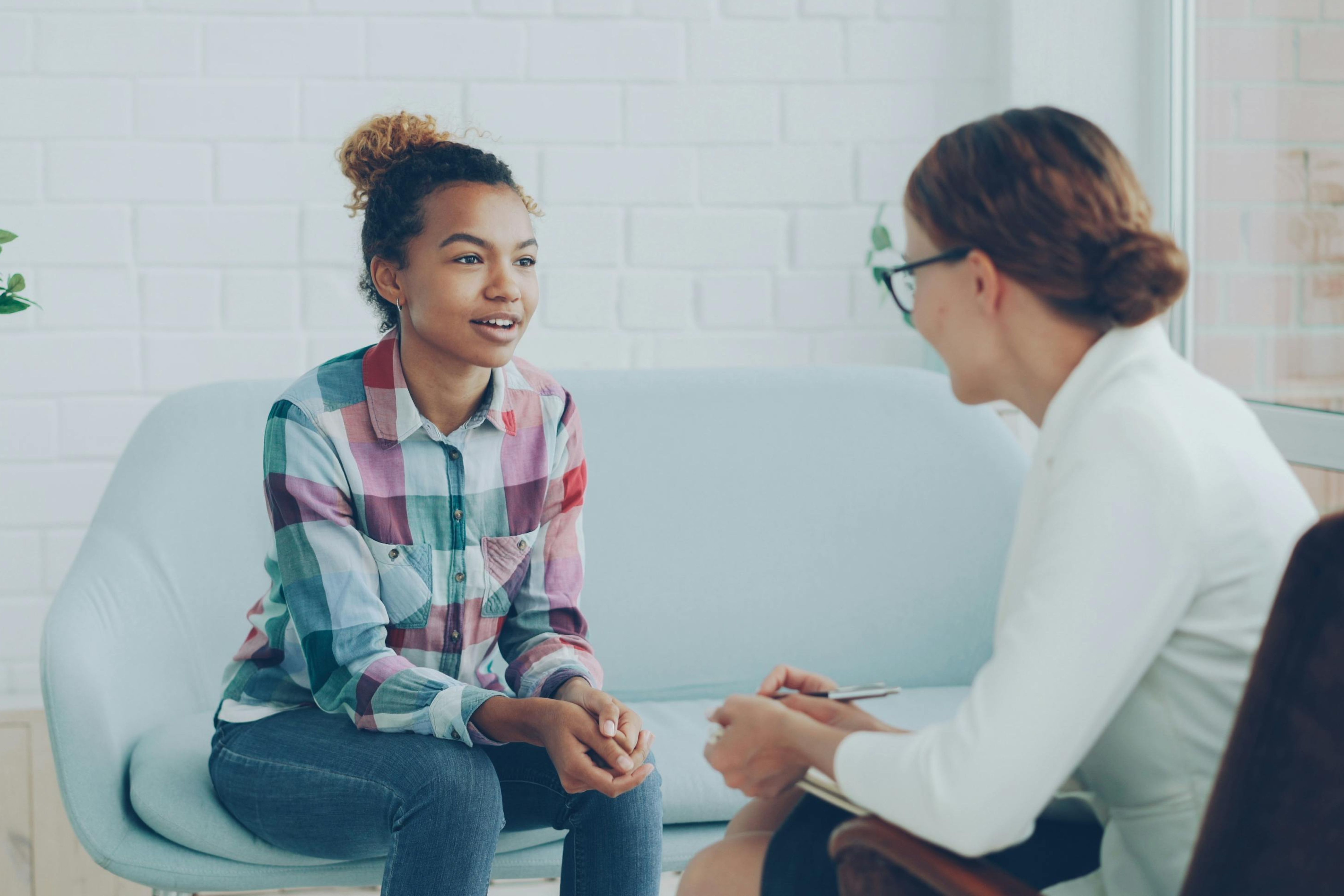 Young person in consultation with a counselor in a modern office. 