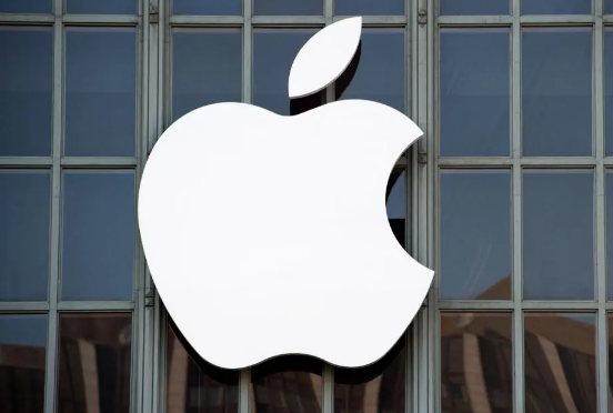The white Apple logo on the exterior of a glass building