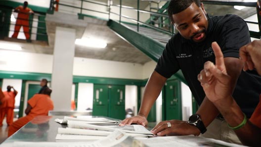 The Harris Center staff member consulting with a inmate in the common area