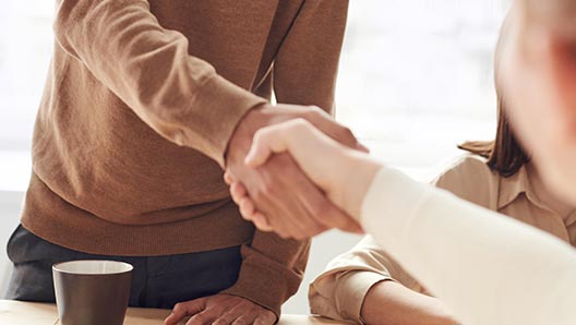 Low-angle closeup of a handshake between to satisfied business associates