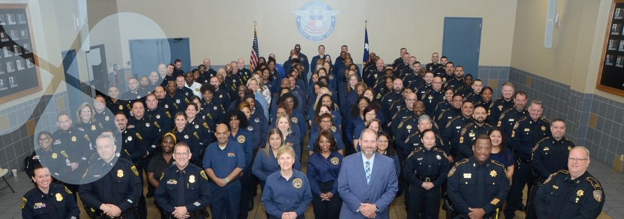 The Harris Center Crisis Services staff members lined up for an indoor group picture with CEO, Wayne Young